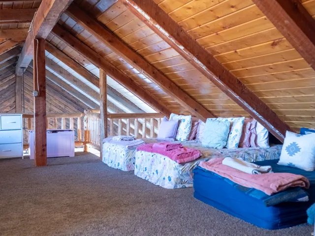 Bedroom featuring wood ceiling, carpet flooring, and vaulted ceiling with beams