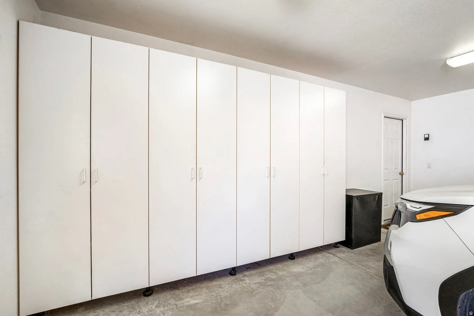 2 car garage has built in cabinets for storage