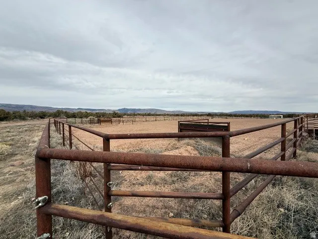 View of yard with an enclosed horse arena and a view of rural / pastoral area