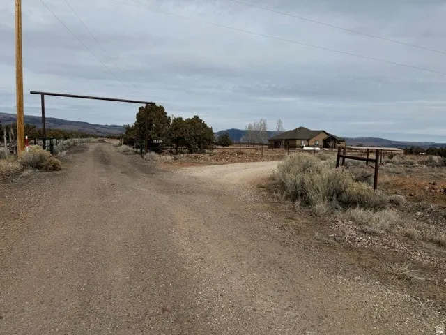 View of dirt / gravel road with a view of countryside