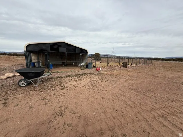 View of yard with an outdoor structure, a view of countryside, and an exterior structure