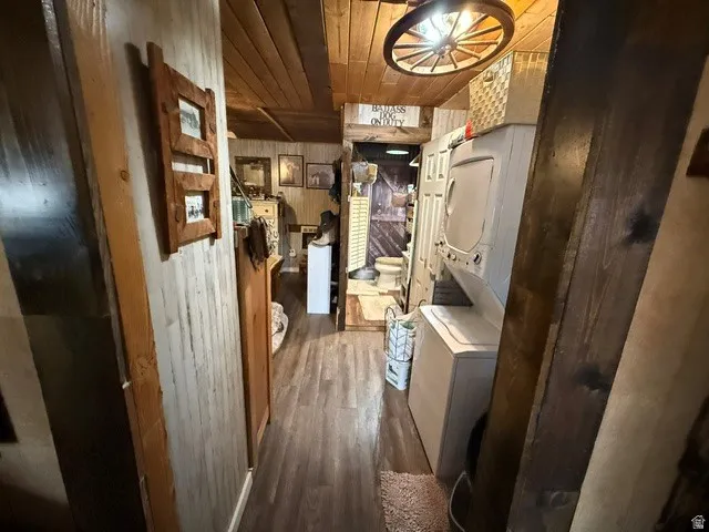 Storage area featuring stacked washer and clothes dryer