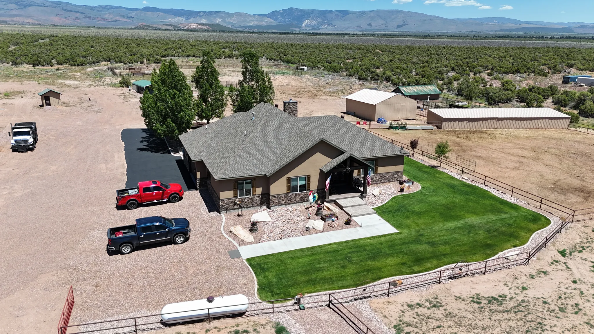 Spacious property featuring a single-story residence with a pitched roof, front entry porch, and partial stone facade