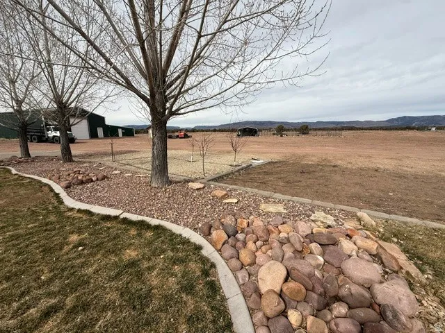 View of green lawn featuring a view of rural / pastoral area