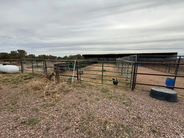 View of yard with an outdoor structure, an exterior structure, and a view of countryside