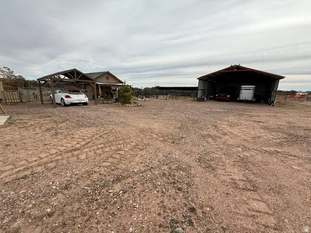 View of yard featuring a detached carport and driveway