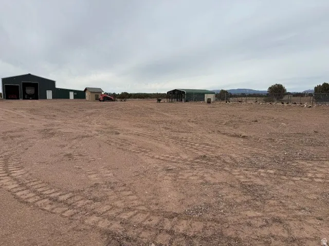 View of yard with an outbuilding, a pole building, a view of rural / pastoral area, and a garage