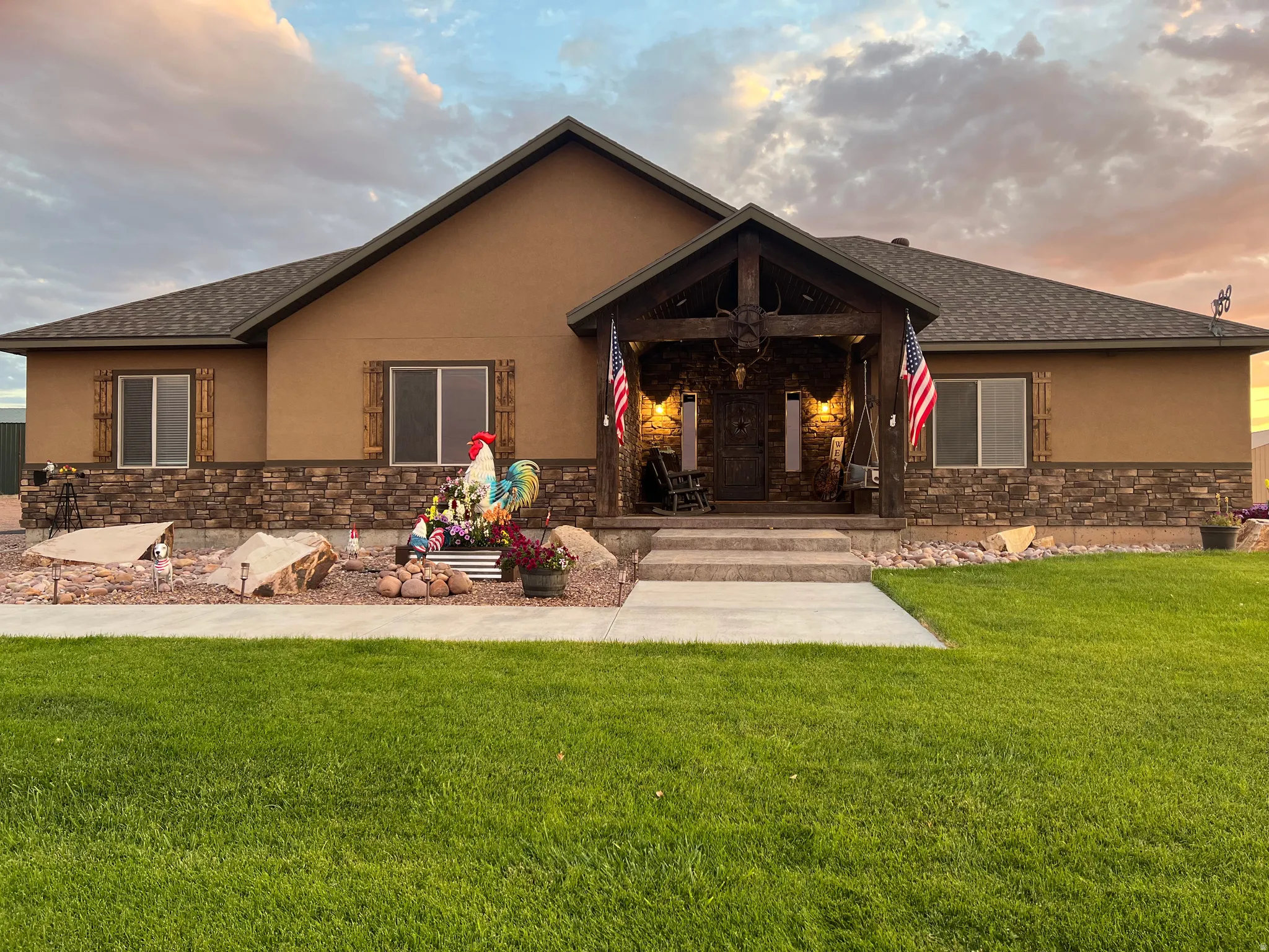 Exterior showcasing a combination of stucco and stone veneer siding