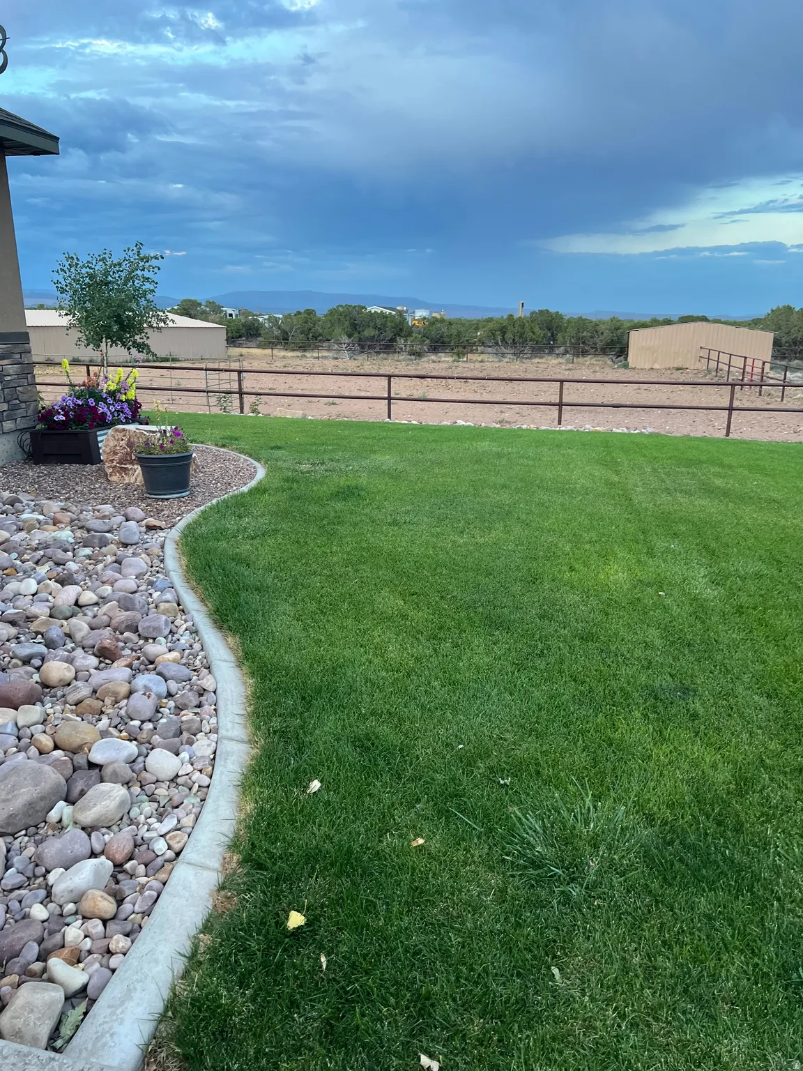 Manicured lawn with a stone and concrete border
