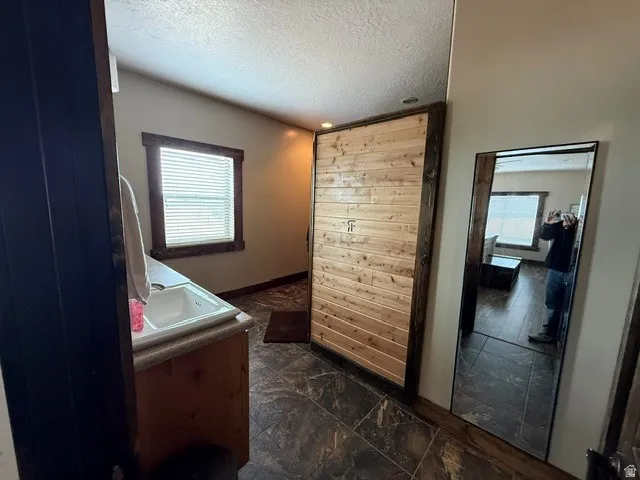 Bathroom with vanity and a textured ceiling