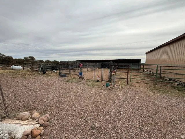 View of yard featuring an outdoor structure and an exterior structure
