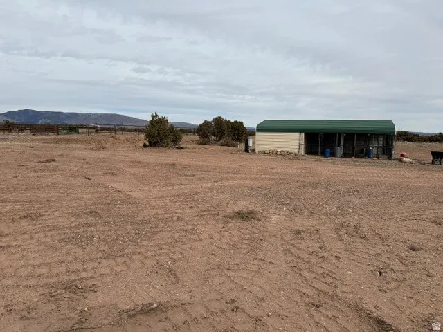 View of yard with a rural view, an outbuilding, and a pole building