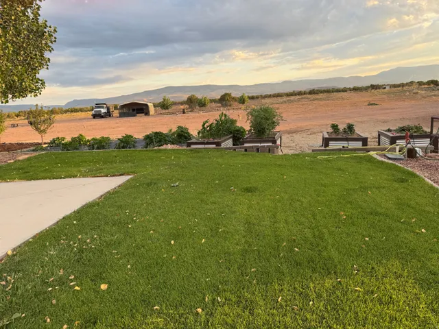 Expansive lawn area with a concrete patio