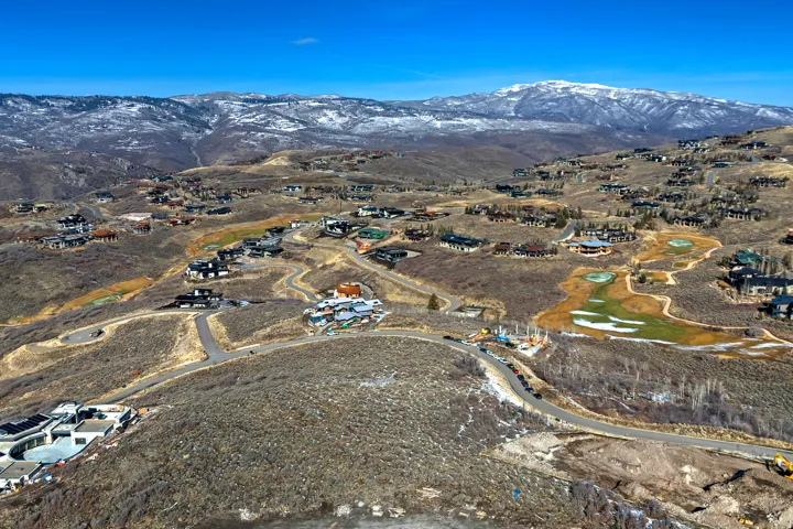View of property location with mountains and nearby suburban area
