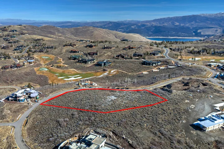 Aerial view of property's location featuring a water and mountain view and property parcel outlined