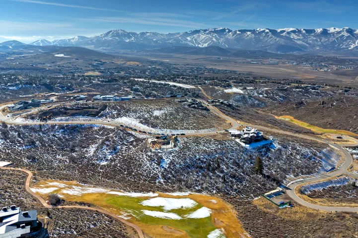 Aerial view of property and surrounding area with a mountainous background