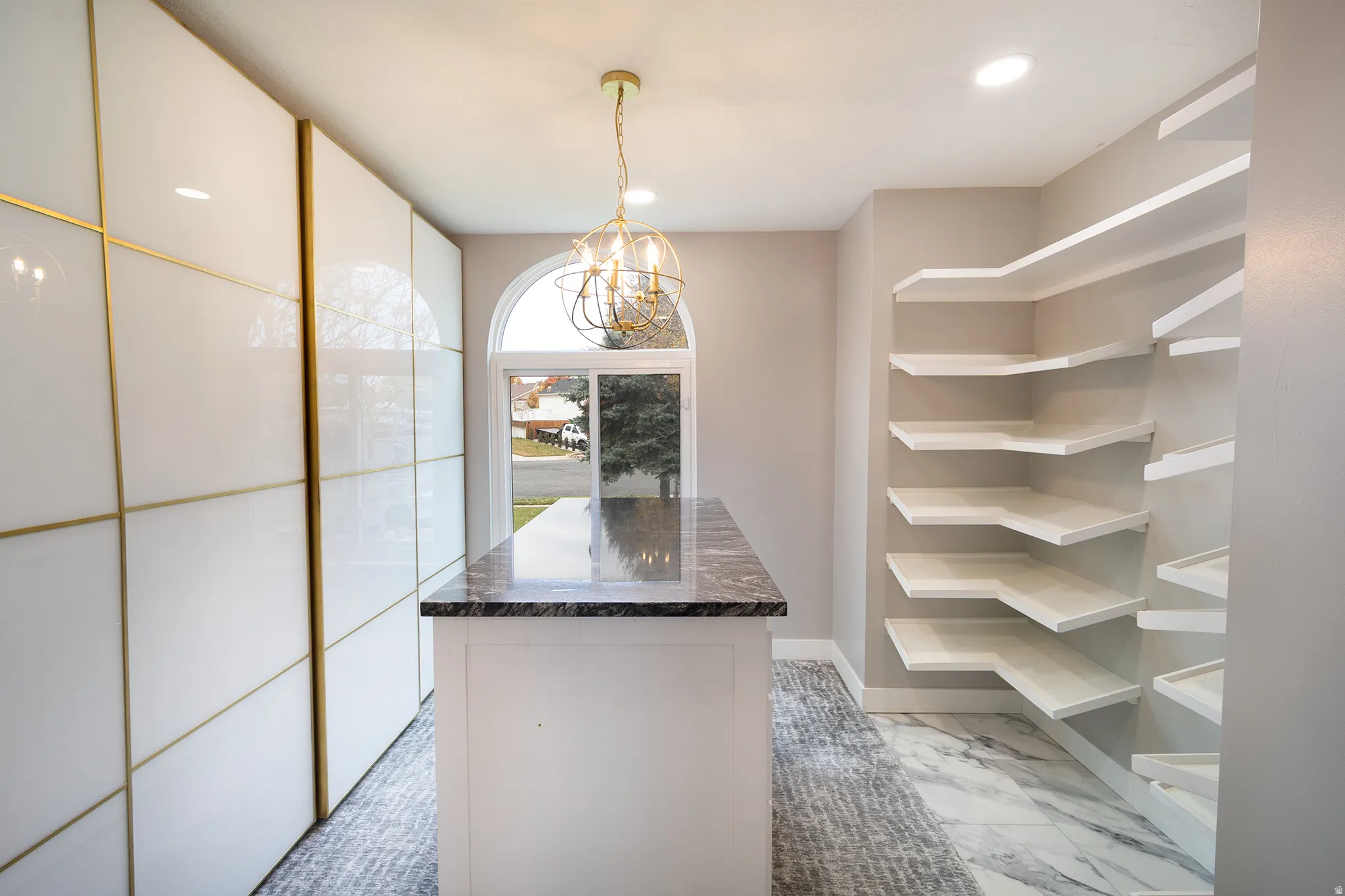 Bedroom 3 on main floor currently set up as closet room, island and tall white closets can be easily removed