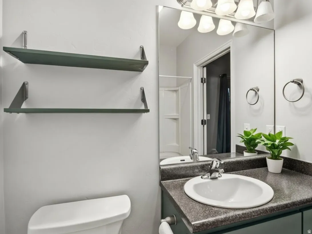 Bathroom with vanity and curtained shower