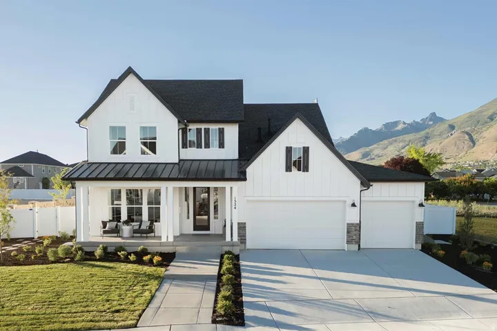 Modern farmhouse with covered porch, board and batten siding, concrete driveway, and roof with shingles