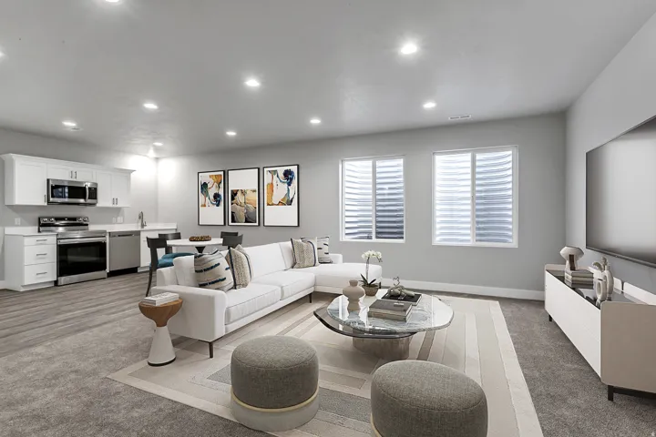 Living area with recessed lighting and light carpet