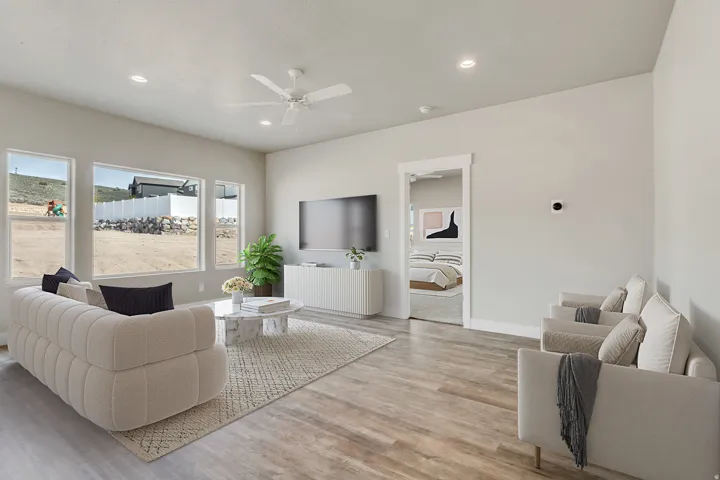 Living room featuring light wood-type flooring, ceiling fan, and recessed lighting