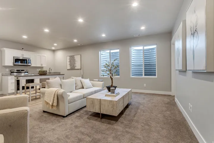 Living area with recessed lighting and light colored carpet