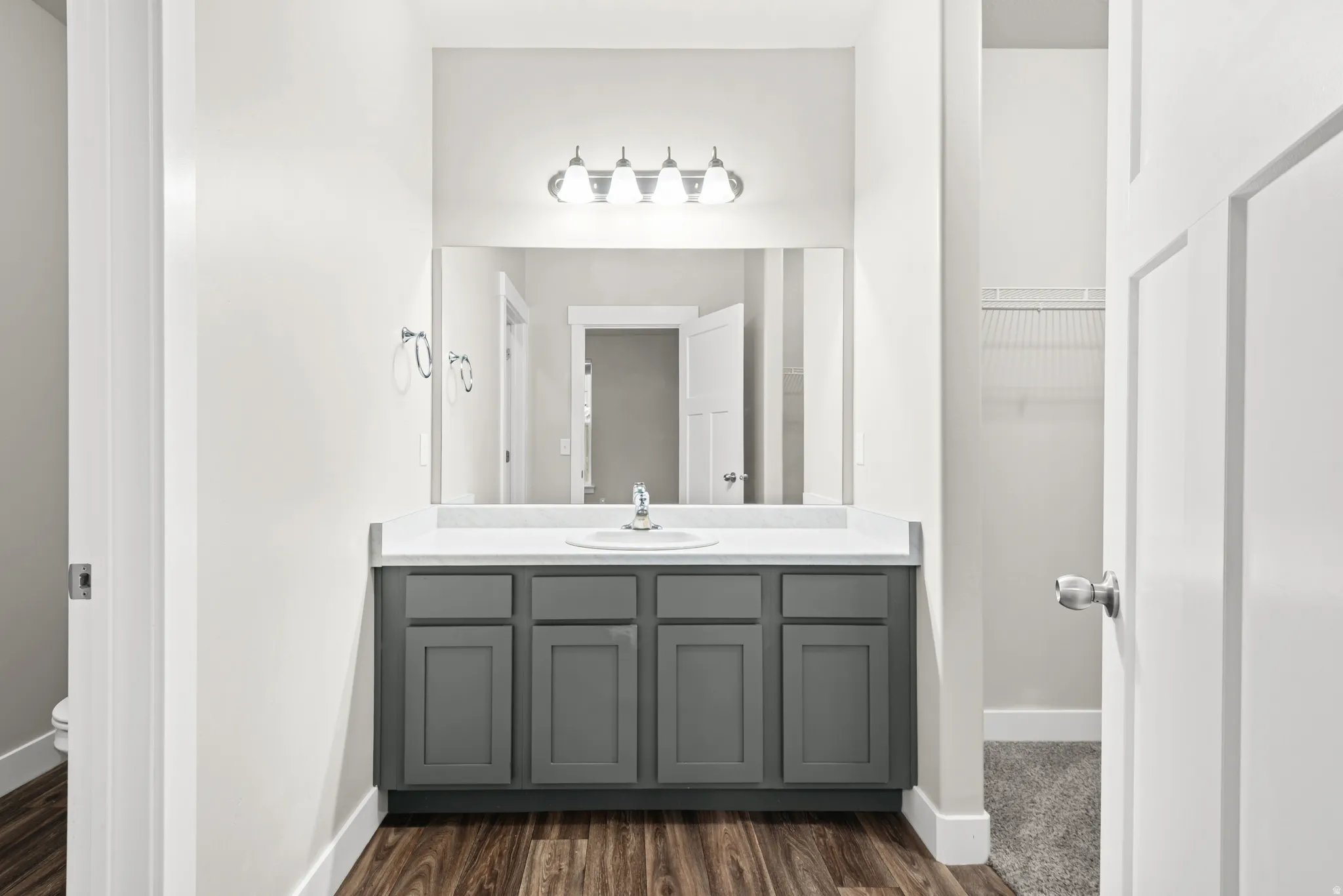 Full bathroom with vanity and dark wood finished floors
