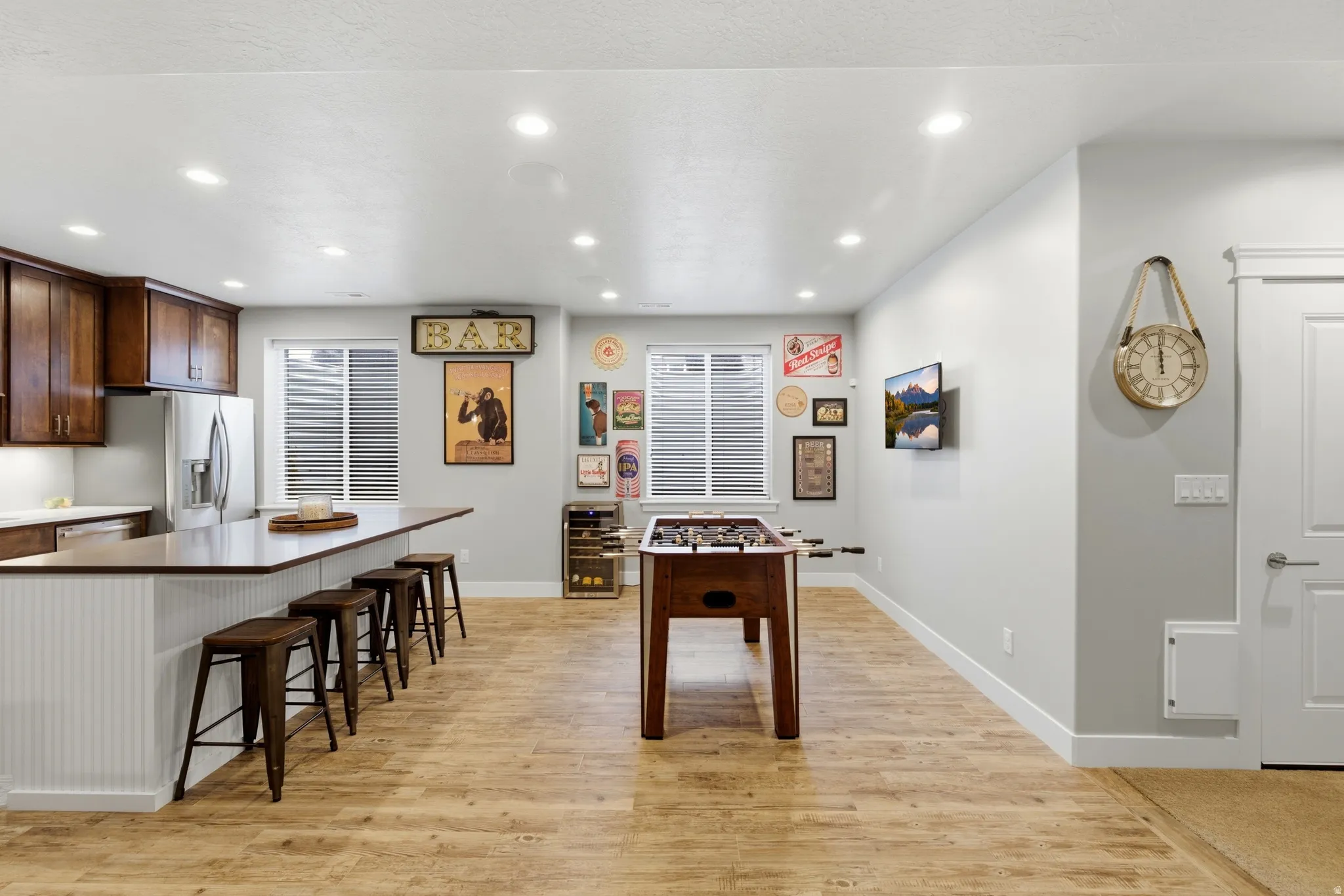 Playroom featuring light wood-style floors, recessed lighting, and beverage cooler