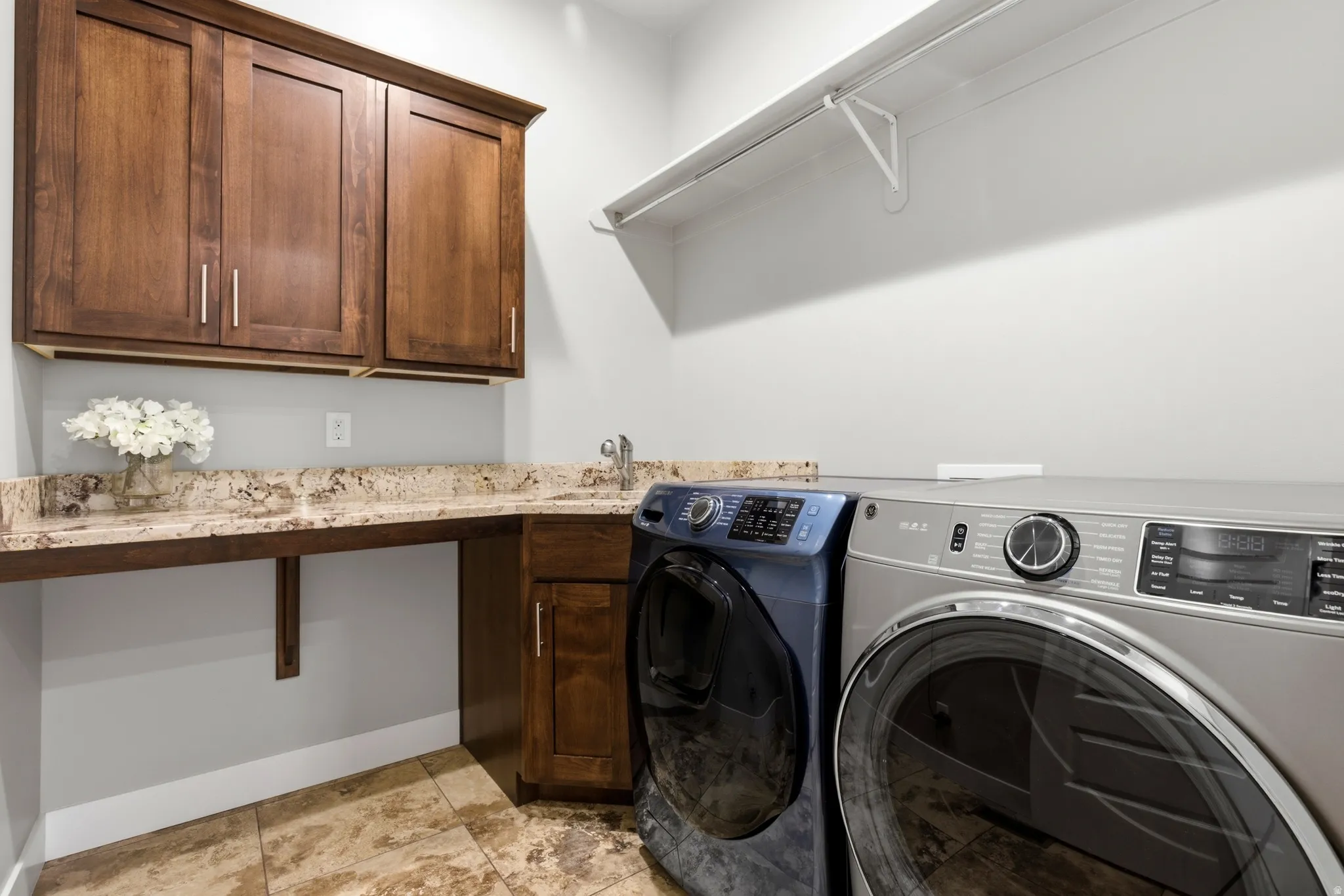 Laundry area with washer and clothes dryer and cabinet space