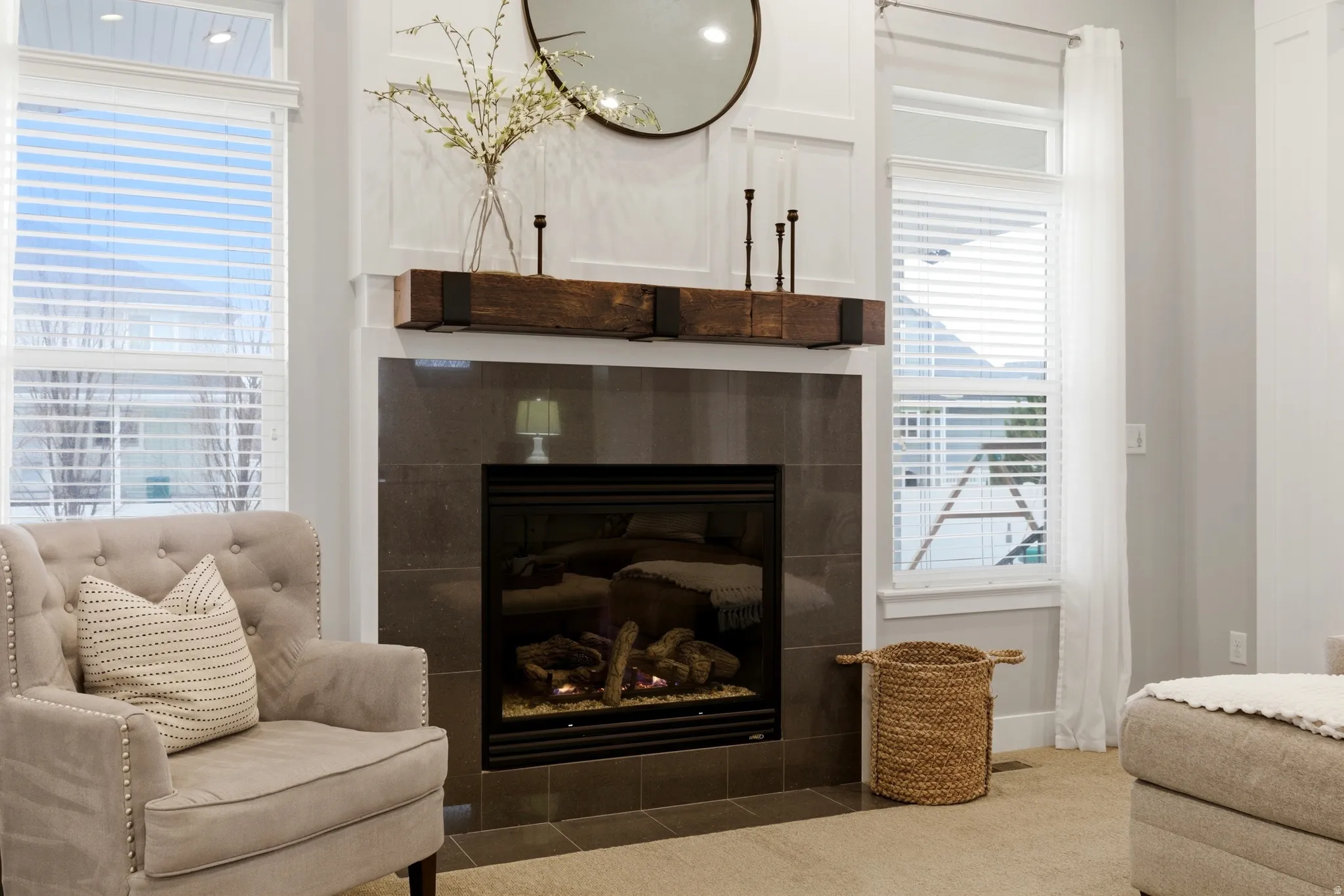 Detailed view of a tiled fireplace and carpet floors