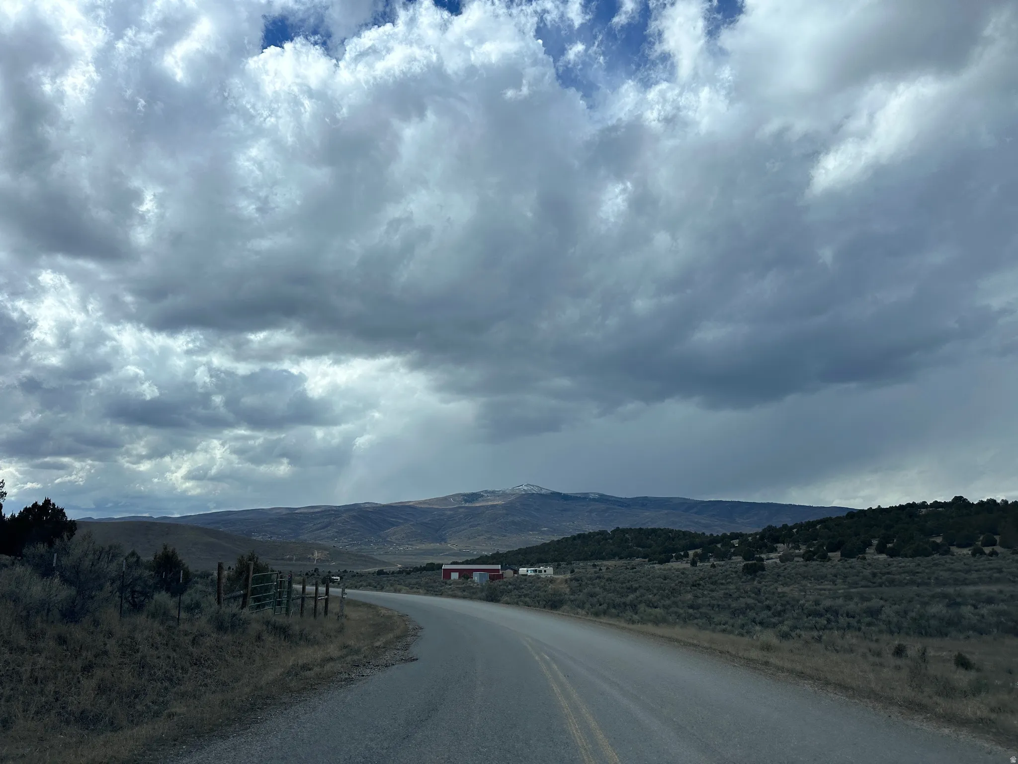 View of asphalt road with a mountain view and a view of countryside