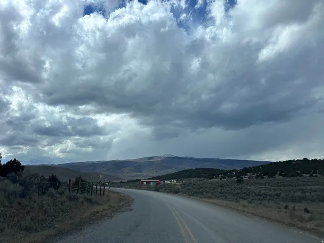 View of asphalt road with a mountain view and a view of countryside