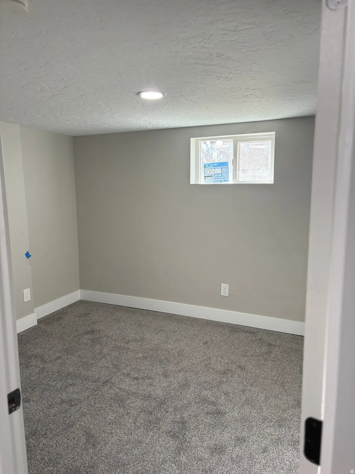 Basement featuring carpet flooring, a textured ceiling, and recessed lighting