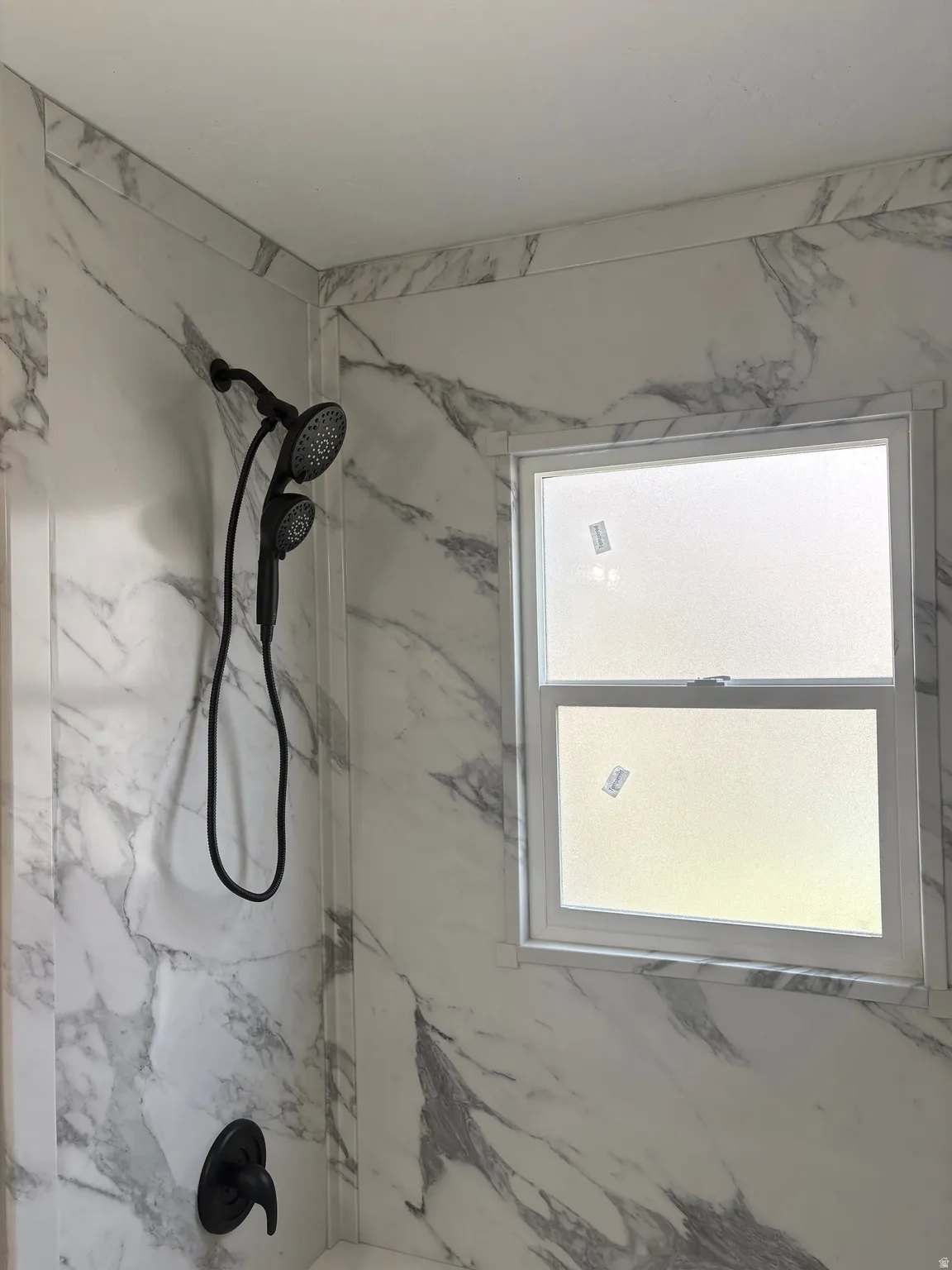 Bathroom with vanity and a combined shower bathtub marble look