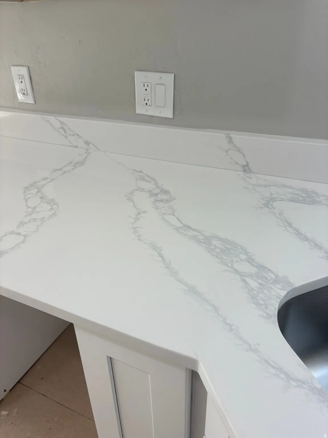 Kitchen view of light stone counters