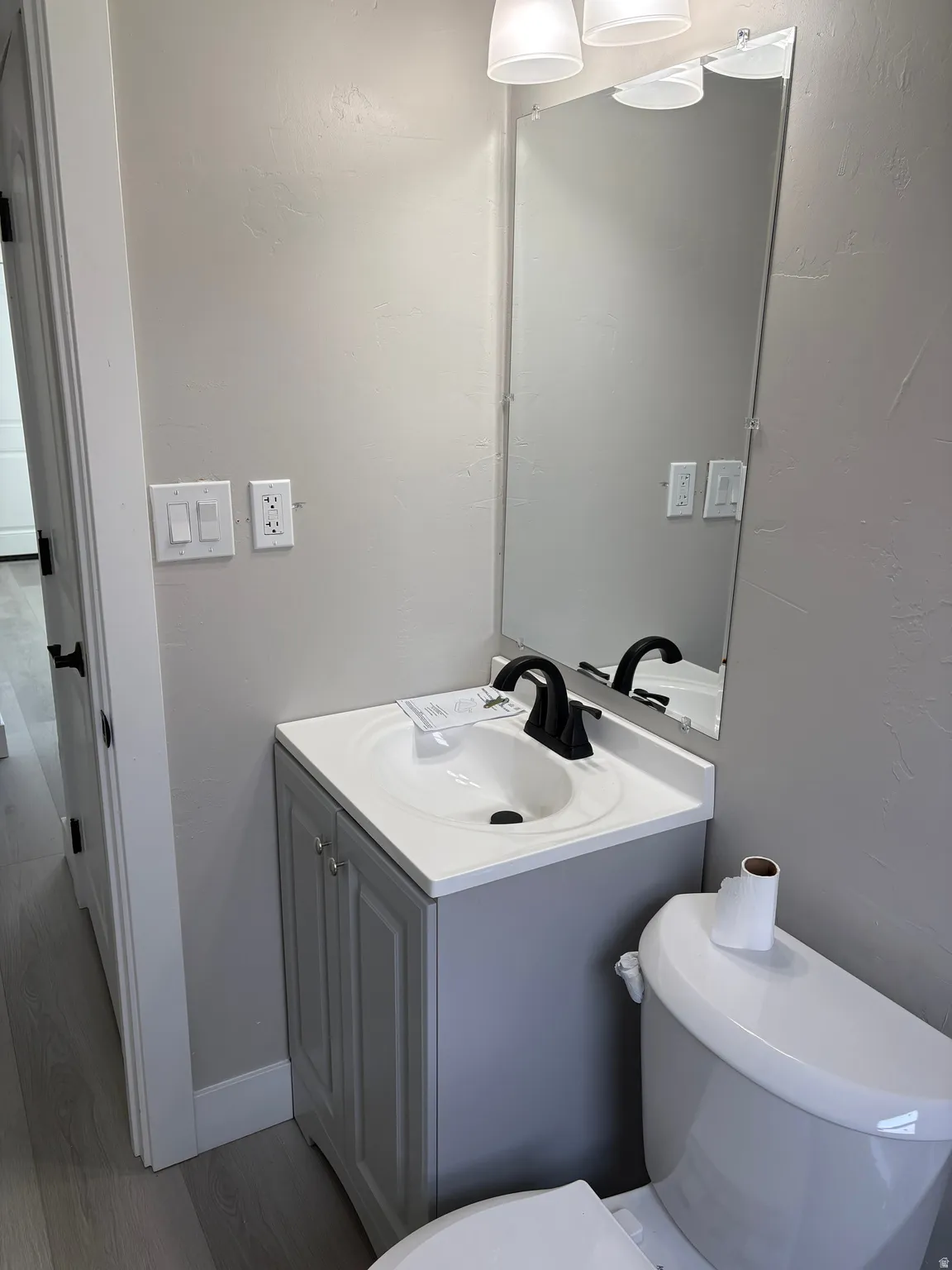 Bathroom with vanity and dark wood-type flooring