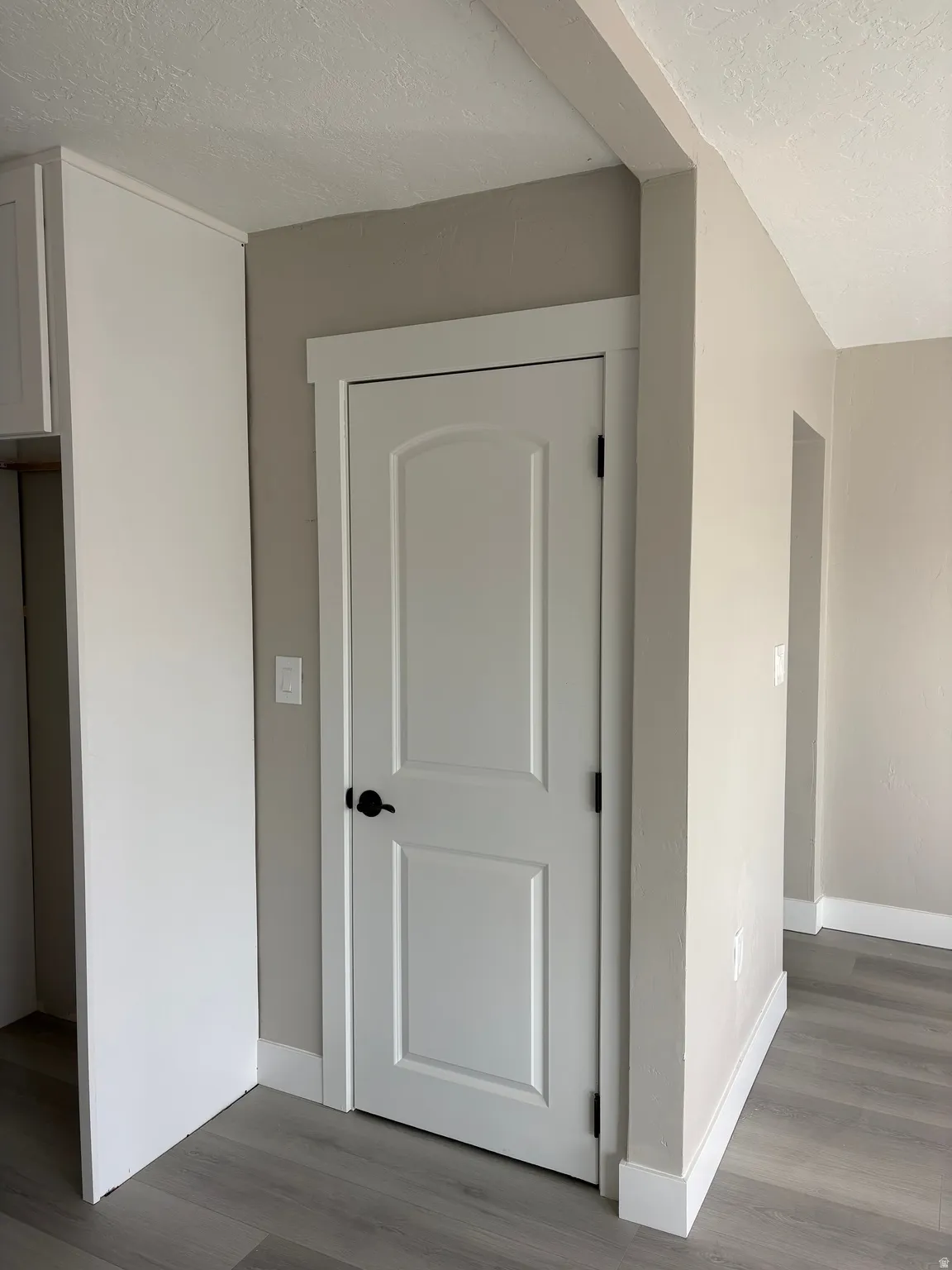 Detailed view of a textured ceiling and wood finished floors