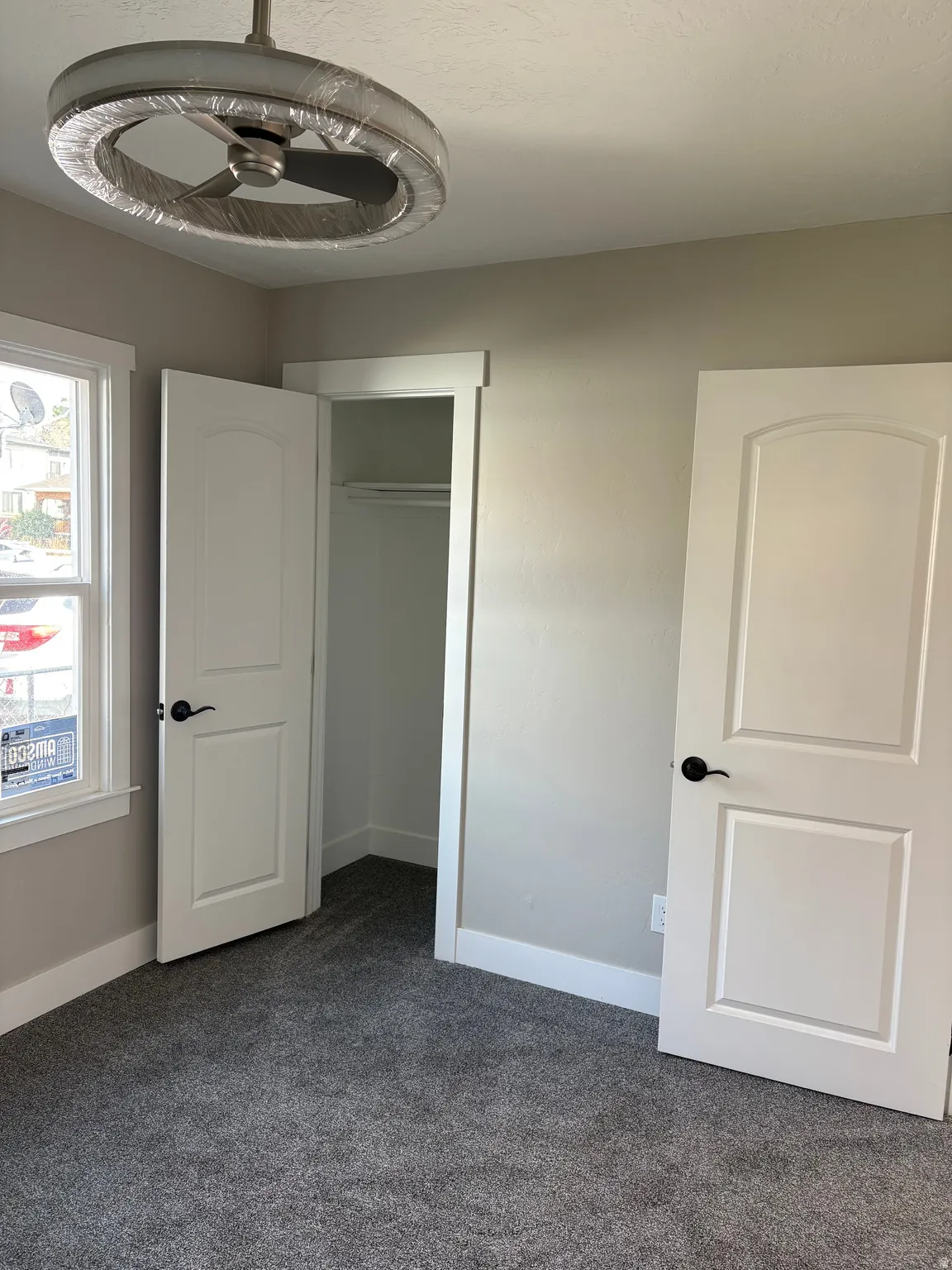 Unfurnished bedroom with dark carpet and a closet