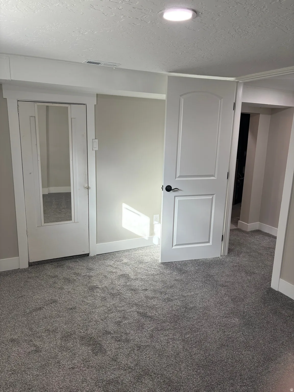 Bedroom 4 closet light grey carpet floors and a textured ceiling