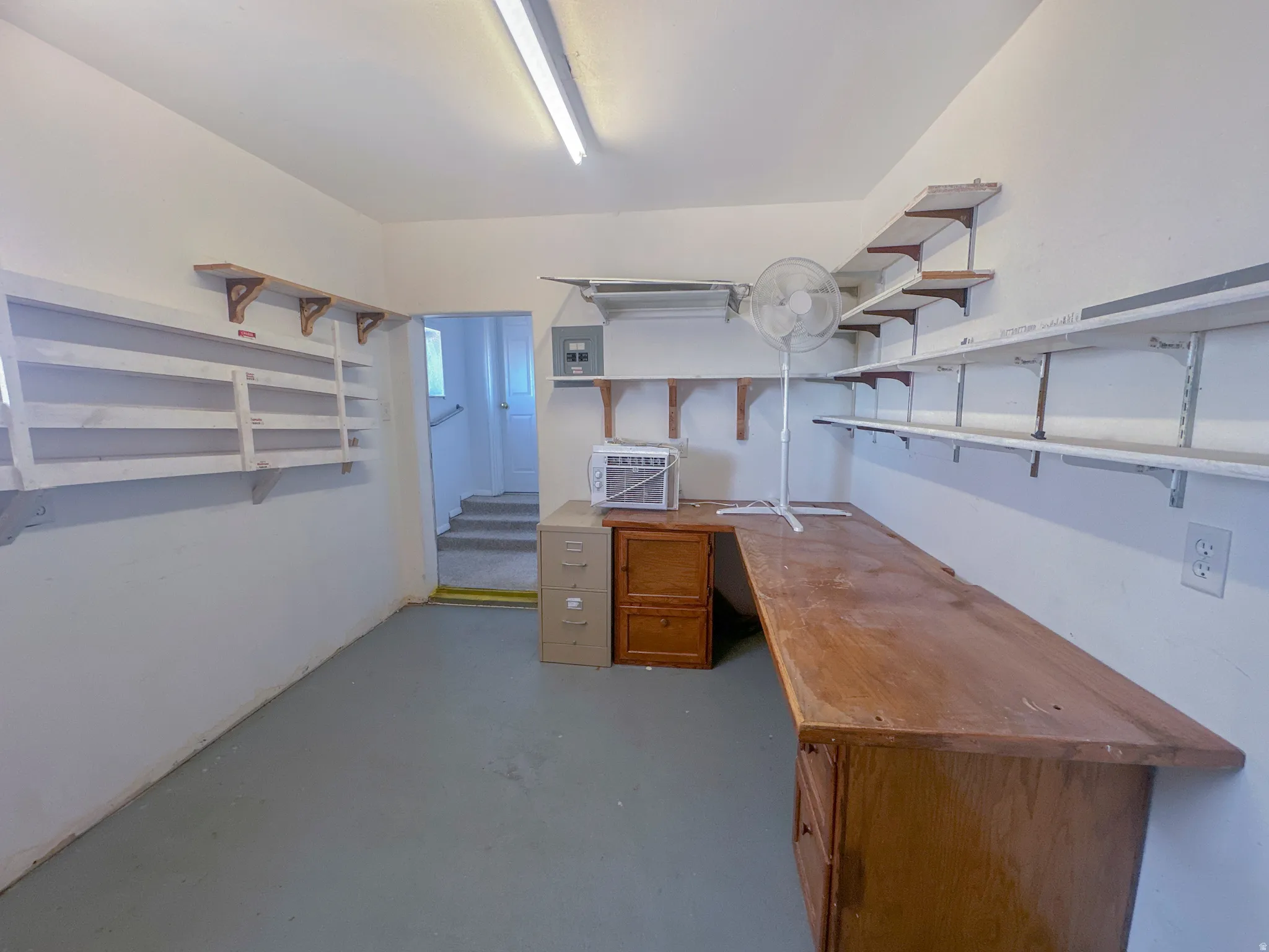 storage room/workshop with concrete floors