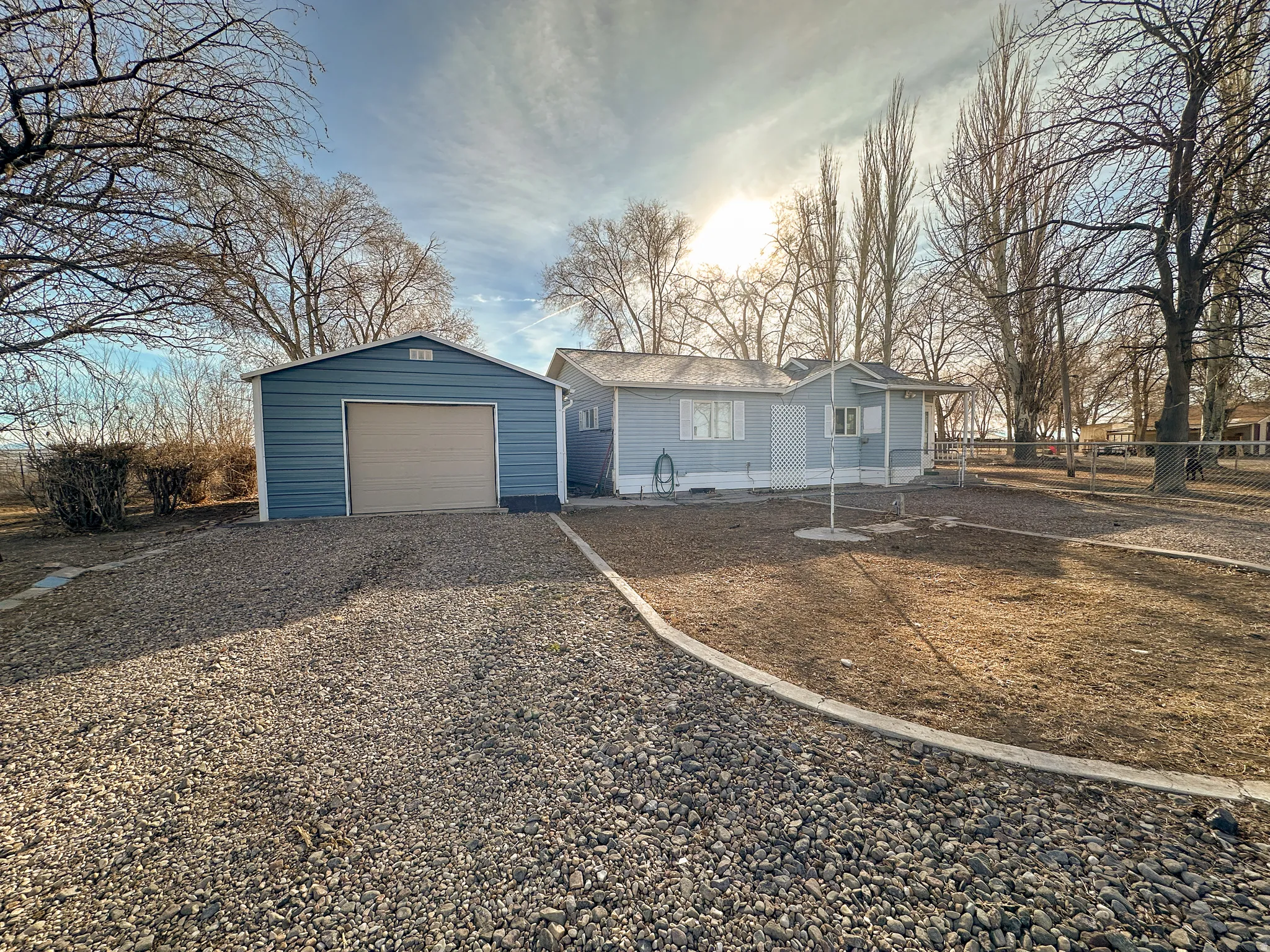 View of front facade, a garage, and driveway