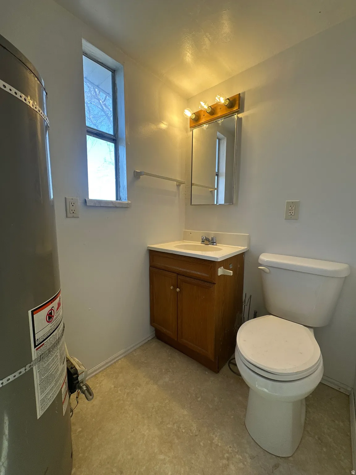 Bathroom featuring vanity and water heater