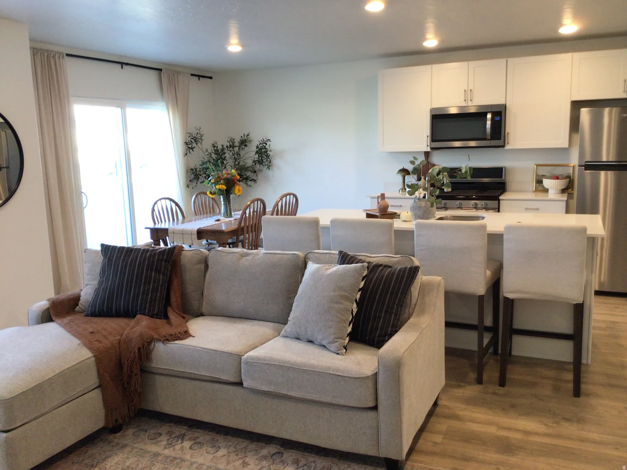 Living area featuring dark wood-style floors and recessed lighting