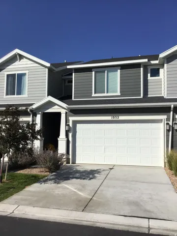 Traditional home with driveway and an attached garage