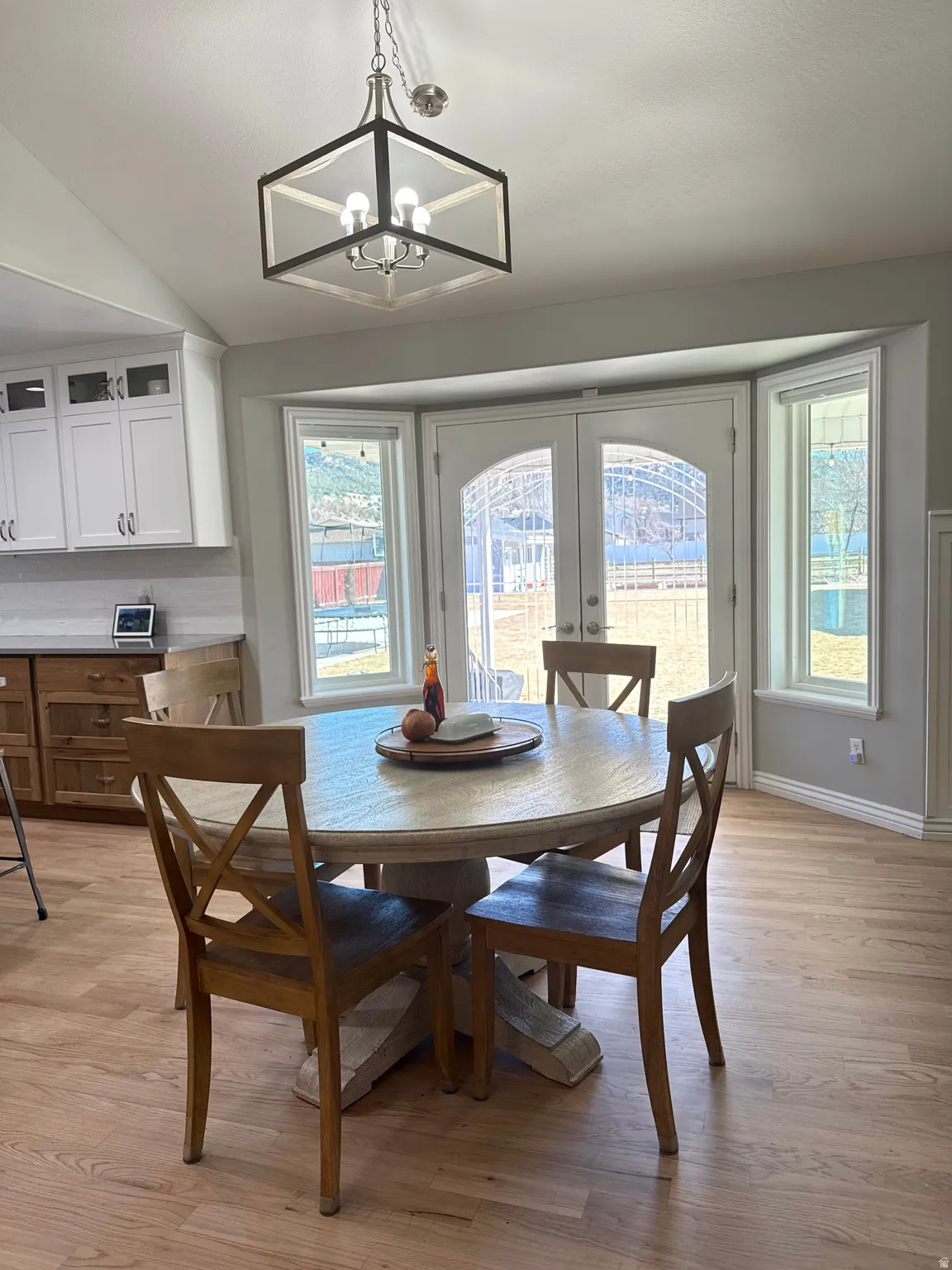 Dining space with refinished hardwood floors, french doors to the back patio and back yard.