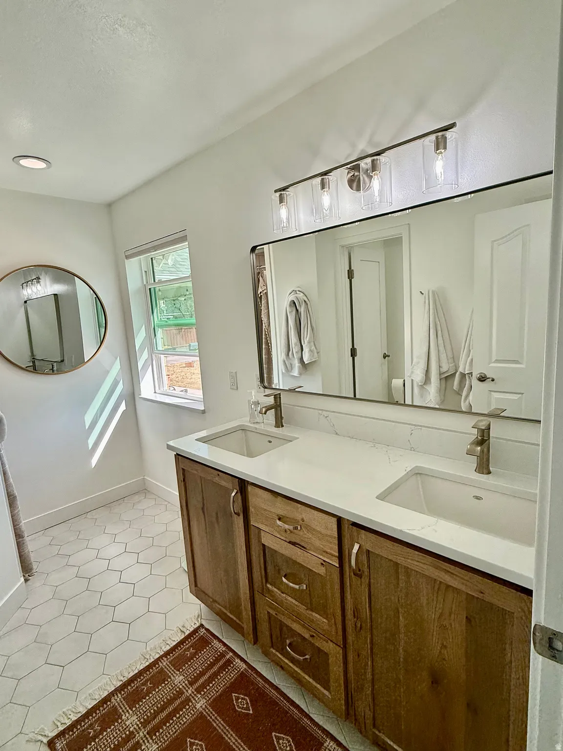 Master Bathroom completely remodeled with upgraded flooring, shower, double vanity, fixtures, paint, and windows.