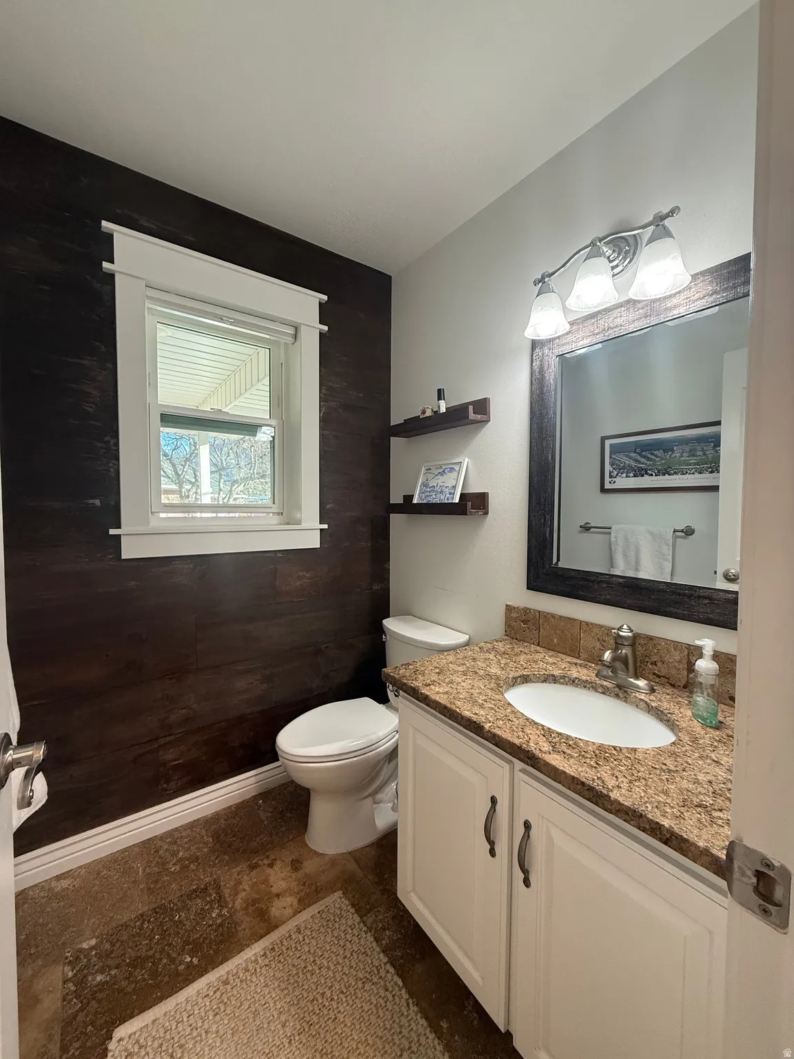 Bathroom with vanity with upgraded toilet and plumbing.