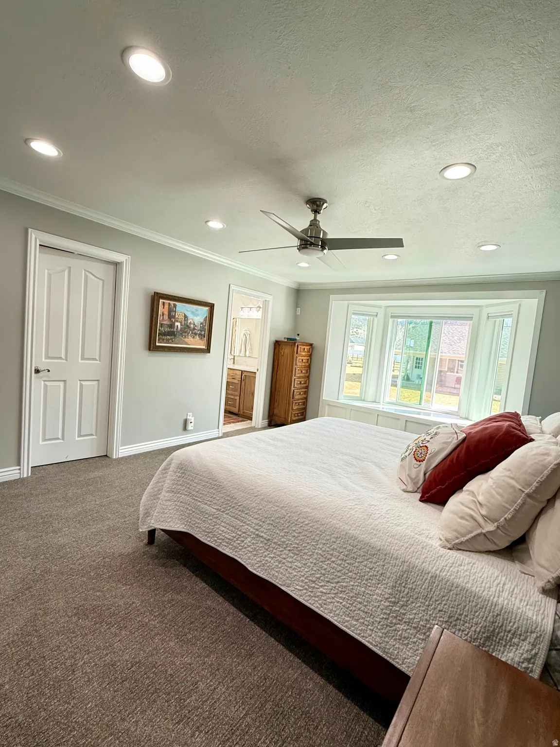 Master Suite featuring new carpet, blinds, paint, closet doors, and ceiling fan.