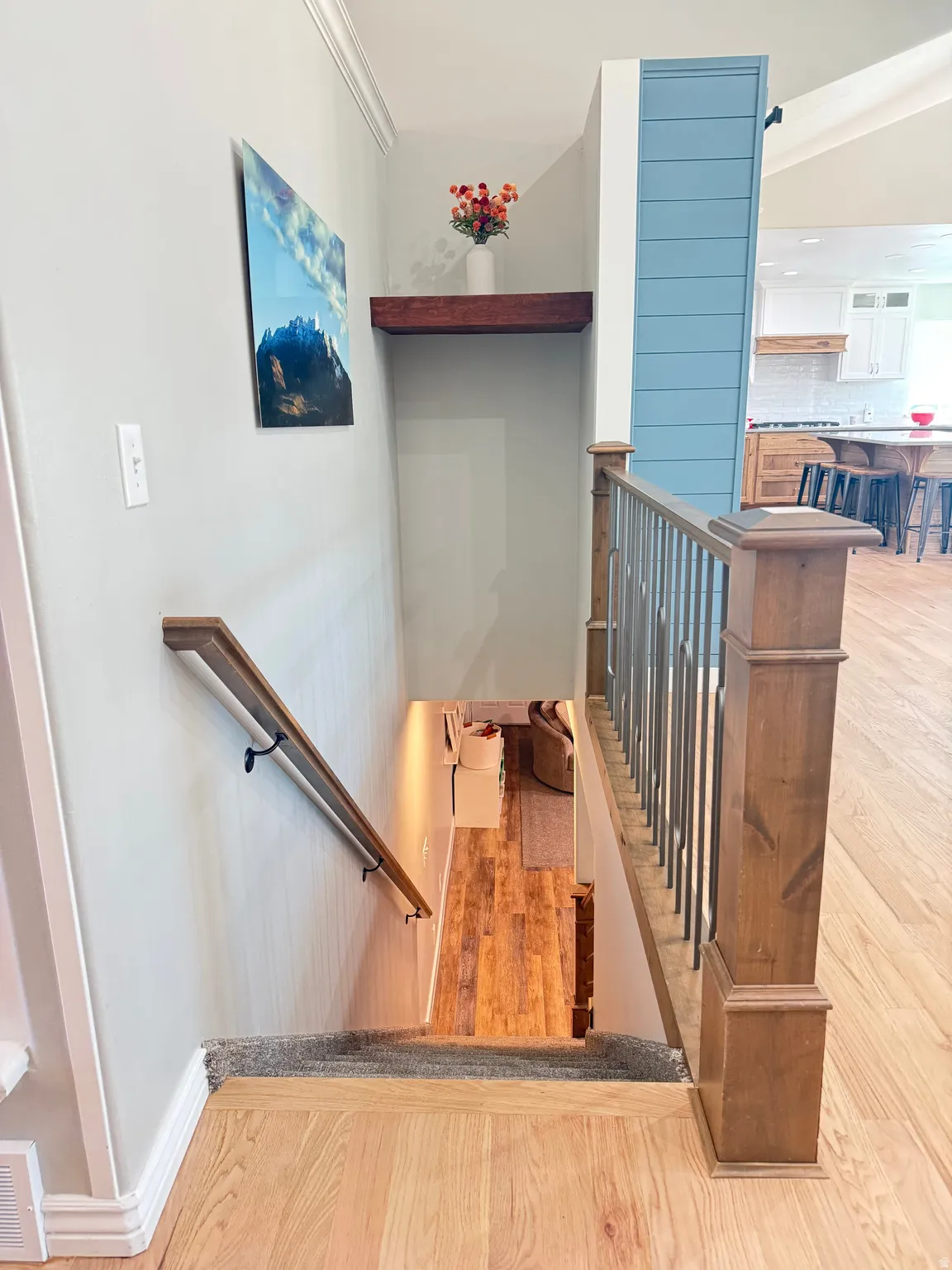 Stairwell to basement level with new carpet and an updated rail.