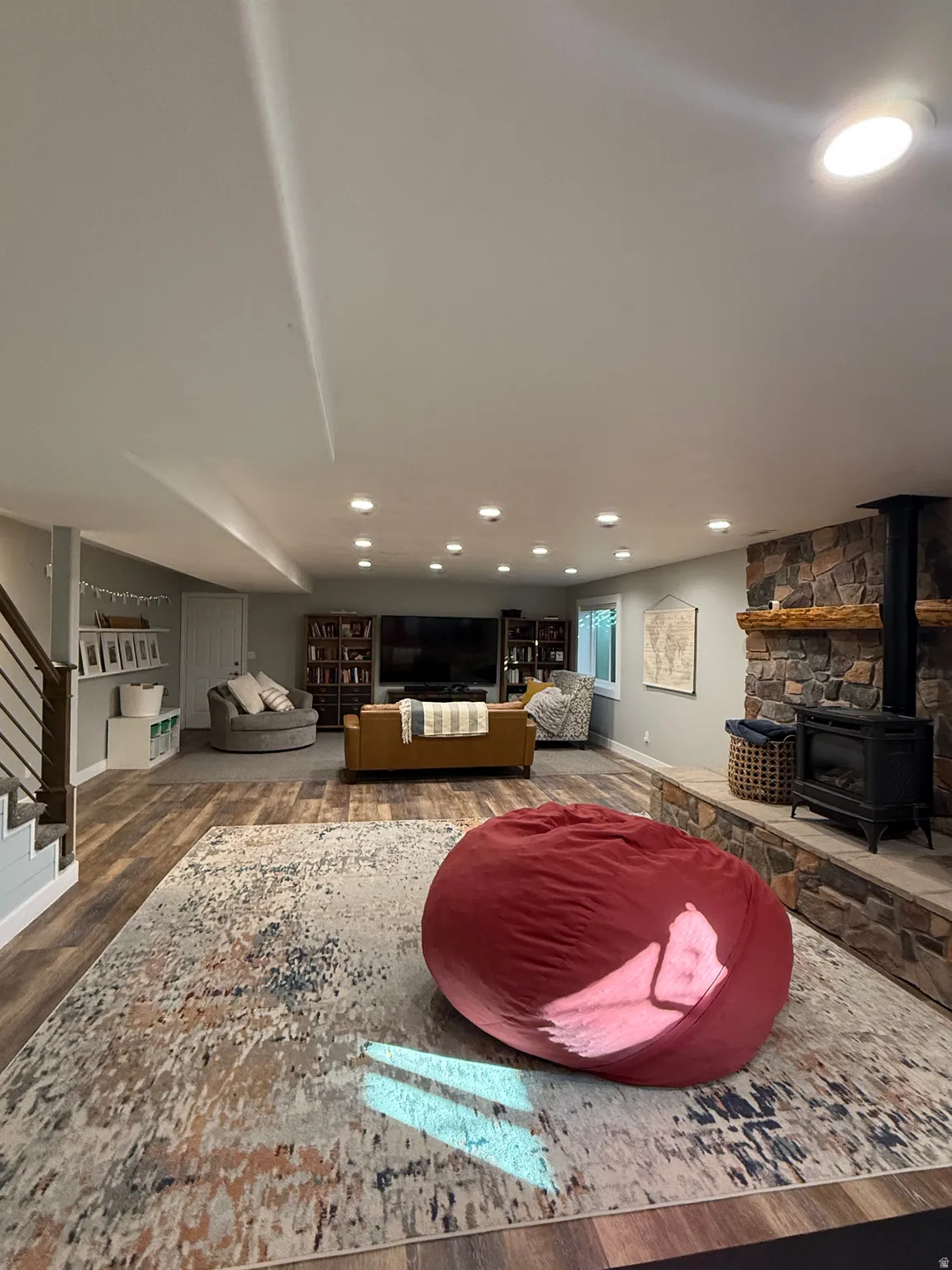 Living area with newer paint and windows, a second fireplace, and the outside basement entrance/stairs.